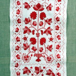 Біле полотно з вишитими червоними квітами