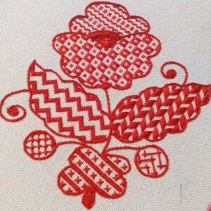 Біле полотно з вишитими червоними квітами